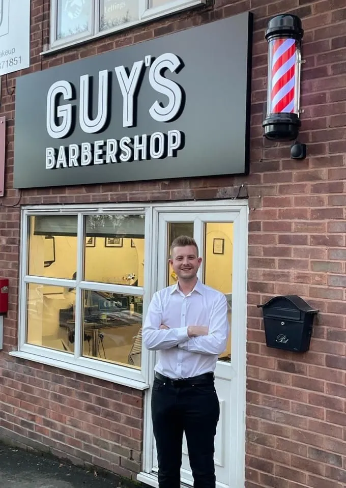 Guy outside Guy’s Barbershop on Lickey Road